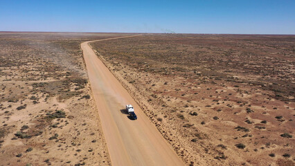Poster - driving through the outback desert country of Australia.