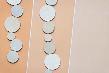 Wall Mural - wooden circle cutouts on striped orange pastel paper pad sheet with paint chip element - macro lens, particular focus