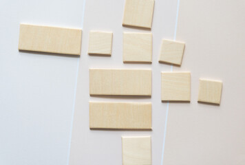 Sticker - square and rectangle wooden shape cutouts on beige paper pad with paint chip element - macro lens, particular focus