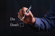 © Bordinthorn - businessman Hand holding pen and choose word do or dont. Personal development and career growth or change yourself concept.