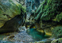 The Turquoise Water Of The River Flowing The Lichen And Moss Covered Chasm Walls In The Beautiful  Patuna Chasm