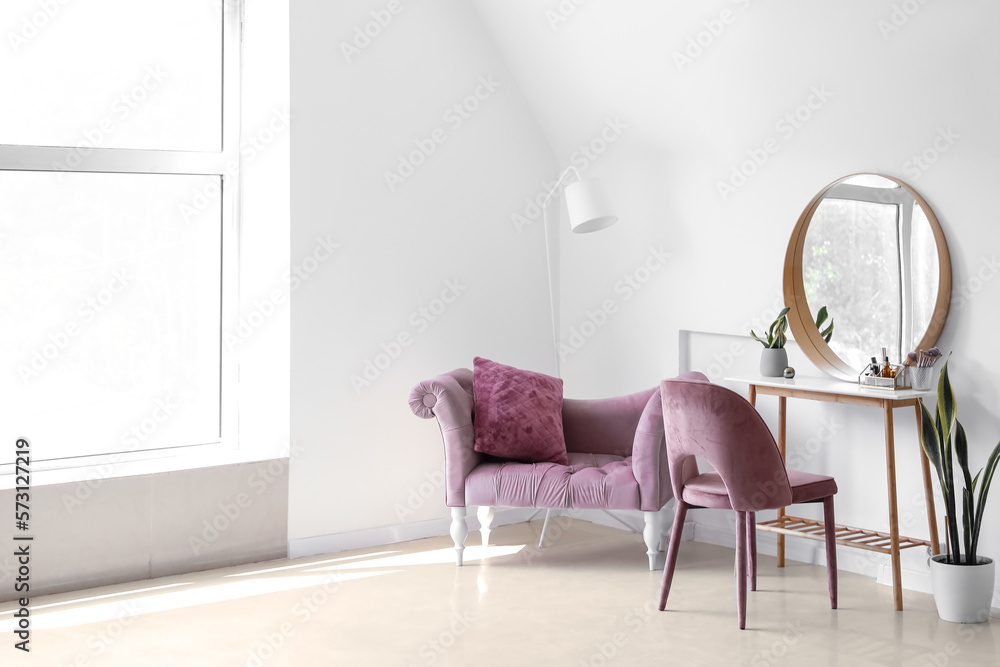Interior of light makeup room with table, mirror and chairs