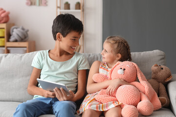 Poster - Little boy and girl watching cartoons on tablet computer at home