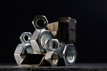 Wall Mural - composition of nuts bolts and scraps of metal laid out on a dark background.