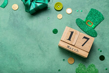 Calendar With Date Of St. Patrick's Day, Paper Leprechaun Hat And Coins On Green Background