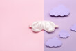 Composition with sleeping mask and paper clouds on color background. World Sleep Day concept