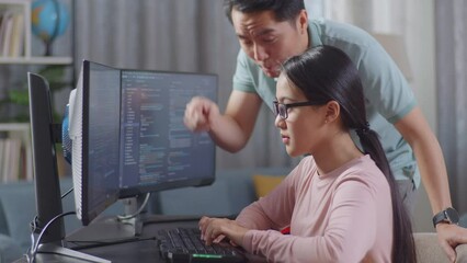 Asian Father Shouting At His Daughter While Creating Software Engineer Developing App, Program, Video Game On Desktop Computer At Home. Terminal With Coding Language
