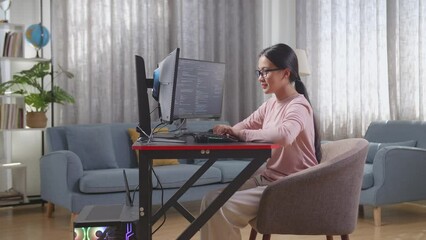 Asian Teen Girl Programmer Creating Innovative Software Engineer Developing App, Program, Video Game On Desktop Computer At Home. Terminal With Coding Language 
