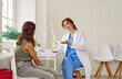 © Studio Romantic - Spine specialist tells teenage girl about structure of spine during medical consultation. Smiling young Caucasian female doctor is showing child anatomical model of spine in her medical office.