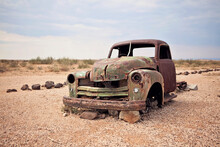 A Rusty Abandoned Truck Sits In The Middle Of The Desert Near Aus, Namibia.