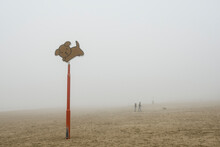 A Dog's Allowed Sign On The Beach Is Seen In The Fog On The Coast Of The Netherlands.