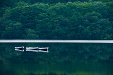 Boats Anchored On A Still Lake In The Peak District