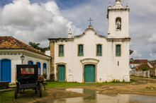Carriage. Horse In Front Of An Old Church. Paraty Is A Colonial And Historic City In Rio De Janeiro. UNESCO World Heritage Site In Brazil.