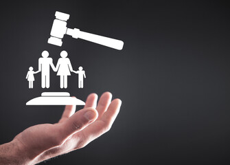 Wall Mural - Male hand holding judge gavel with a family symbol. Family Law