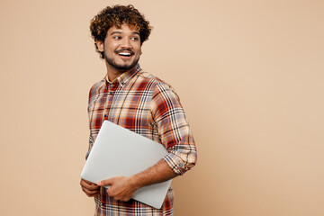 side view young indian it man wear brown shirt casual clothes hold closed laptop pc computer look as