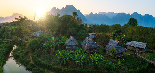 Wall Mural - panoramic beautifull landscape on a small village at sunset, vang vieng, laos.