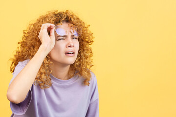 Woman taking off her glasses to see far away