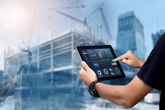 smart construction project management system concept.hands using digital tablet with construction ma