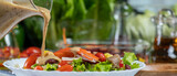 woman chef mix fresh baby cos salad and pour salad dressing in glass blow. Organic Vegetables mix all green salad In glass bowl. Breakfast fresh salad and clean vegetable. copy space panorama 