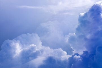 Wall Mural - White cloud on blue sky. See through the plane window in sunny weather bird's eye view.