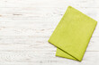 top view with green kitchen napkin isolated on table background. Folded cloth for mockup with copy space, Flat lay. Minimal style
