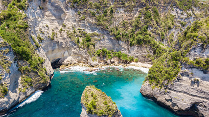 Wall Mural - Aerial drone view to beautiful sandy beach (Diamond beach) with rocky mountains and clear water in Nusa Penida, Bali, Indonesia