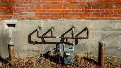 Wall Mural - Rusty pipes on a gas meeting and brick wall