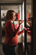 Pregnant Woman Eating Cake In Front Of Refrigerator