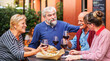© BooNKer - Happy elderly friends drinkingwine during dinner