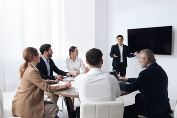 Sticker - Business conference. Group of people listening to speaker report near tv screen in meeting room