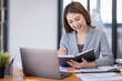 © David - Young asian business woman manager accounting analyst checking bills, analyzing sales statistics management, taxes financial data documents or marketing report papers working in office using laptop.