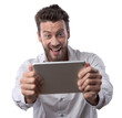 © stokkete - Cheerful man watching videos on tablet