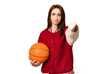 Canvas Print - Young basketball player woman over isolated chroma key background showing thumb down with negative expression