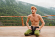 © Drobot Dean - Tired man sitting and resting after workout on terrace in mountains