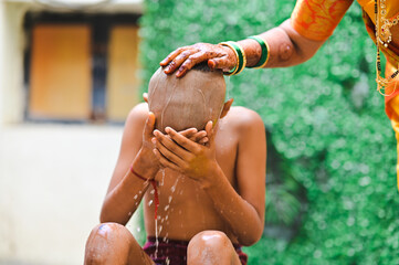 Boy Bathing for hindu worship ceremony. Hindu lifestyle. Holy spring water. Indian boy thread ceremony rituals. Maharashtra culture