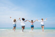 © kelvn - Happy friends at beach party runs together on the beach having fun in a sunny day, Beach summer holiday sea people concept