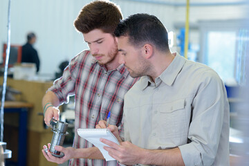 two men working together in a workshop