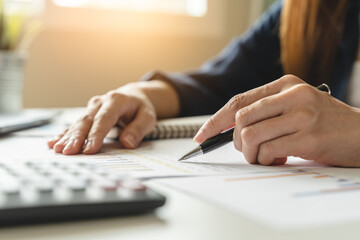 women business people use calculators to calculate the company budget and income reports on the desk