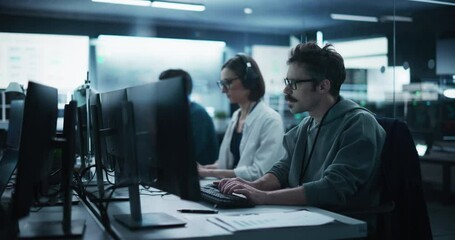 Portrait of a Focused Computer Engineer Working in a Technological Office Facility. Research and Development Department Writing Software Code for an Innovative Online Program for a Global Enterprise
