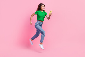 Sticker - Full length photo of shiny pretty lady dressed green t-shirt jumping high typing modern device isolated pink color background