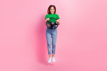 Sticker - Full length photo of sweet adorable lady dressed green t-shirt driving car jumping high isolated pink color background