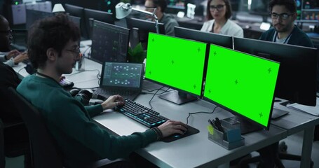 Wall Mural - group of diverse multicultural men and women working on desktop computers in a research center. youn