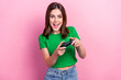Portrait of overjoyed cheerful girl hands hold controller play video games isolated on pink color background
