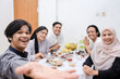 © Gatot - POV of young muslim people taking selfie during eid mubarak or break fasting moment.