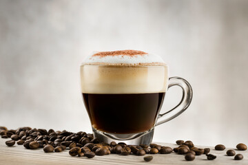 Wall Mural - Cappuccino in glass cup on wooden table with coffee beans.