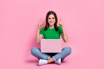 Sticker - Full length photo of cute lady dressed green t-shirt texting modern gadget pointing up empty space isolated pink color background