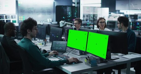 Wall Mural - group of diverse multicultural men and women working on desktop computers in a research center. youn