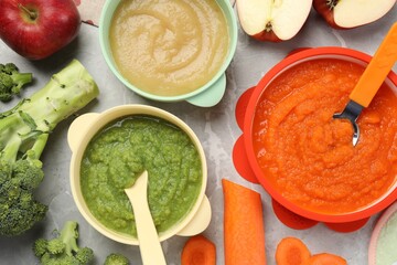 healthy baby food. different tasty puree in bowls on light grey marble table, flat lay