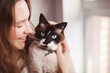 © Tatyana Gladskih - Close up of lovely young woman kissing cat at home