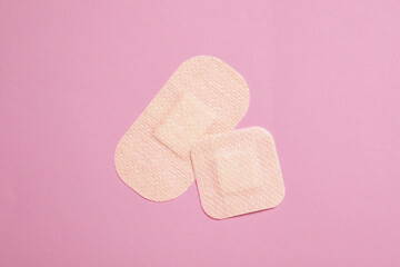 contraceptive patches on pink background, top view